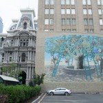 This mural covers a portion of the parking lot you’ll pass walking down Market toward City Hall. Call 215-525-1577 to hear the stories behind the murals. Press 3# to hear about this mural.